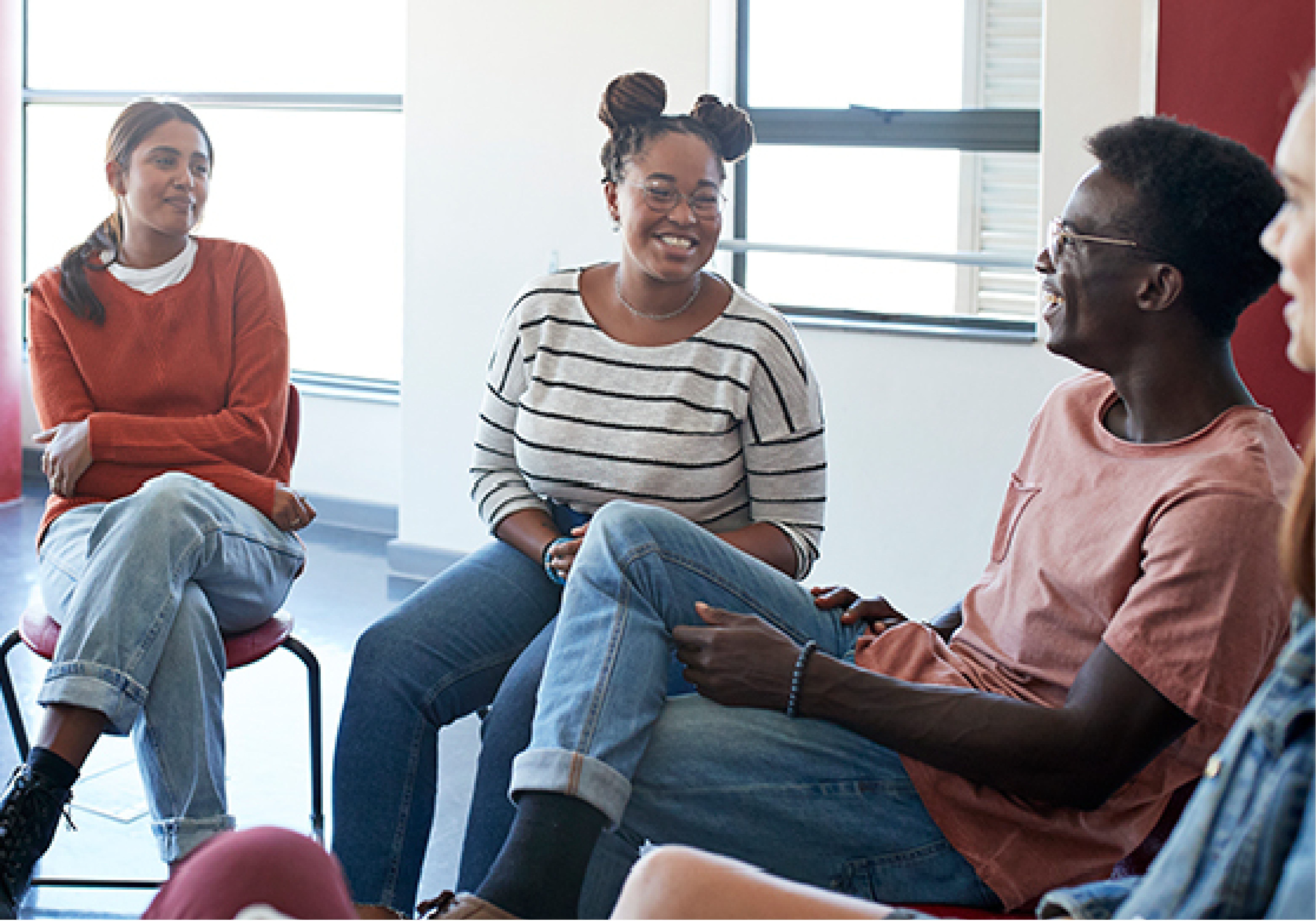 Mental Health Box: Students sit in a casual group setting, smiling and talking during a mental health support session.