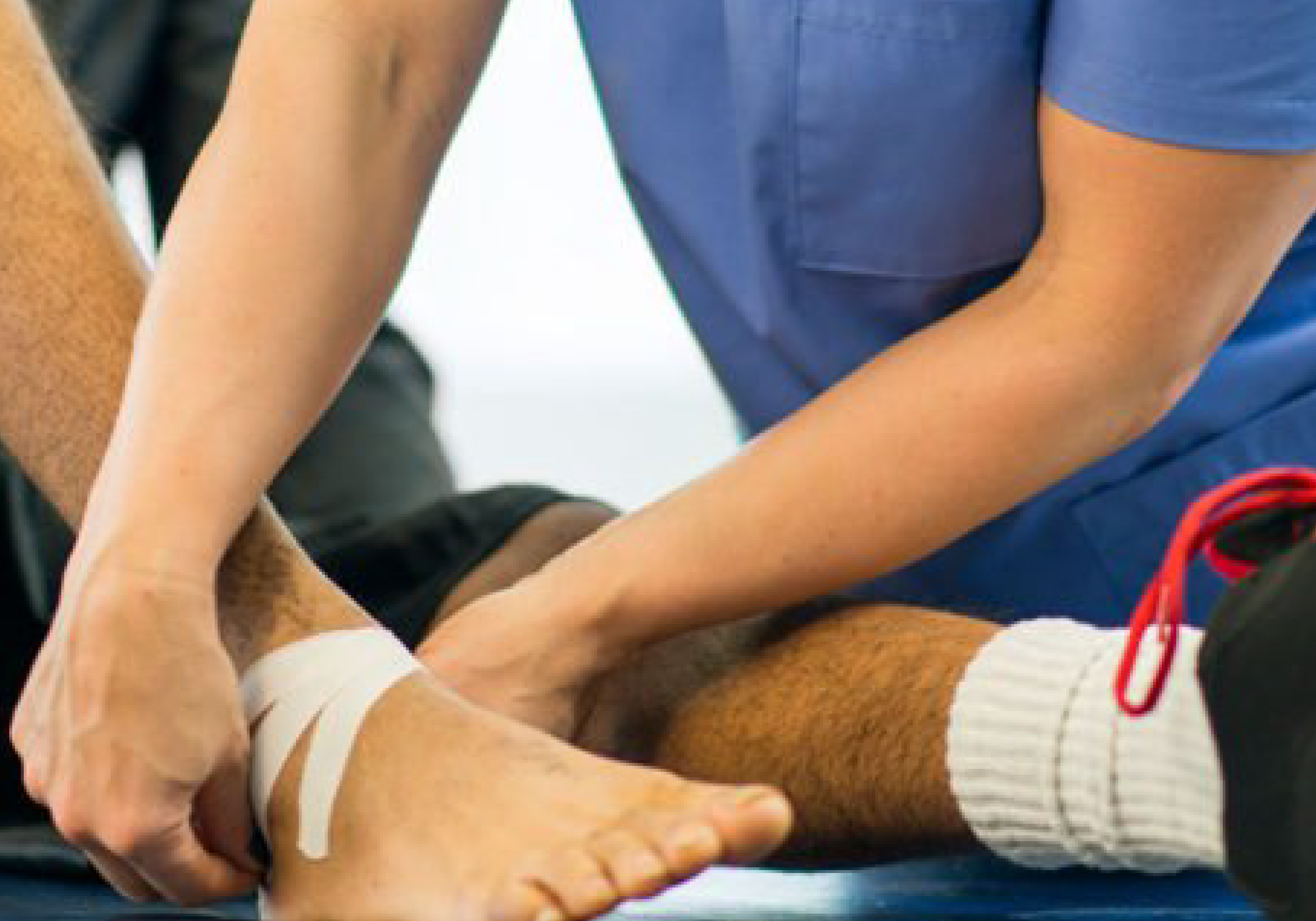 Injury & Illness Box:Healthcare professional wrapping an injured ankle with medical tape, representing care for sports injuries or physical ailments.