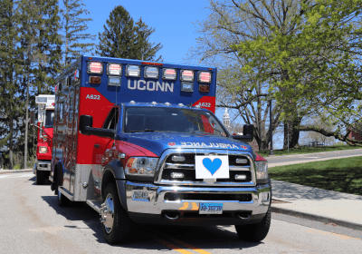 UConn-branded ambulance parked on campus, representing student urgent care and emergency medical services.