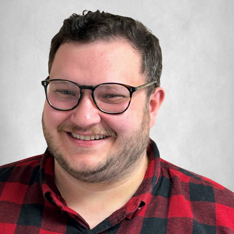 Professional headshot of Adam Coley