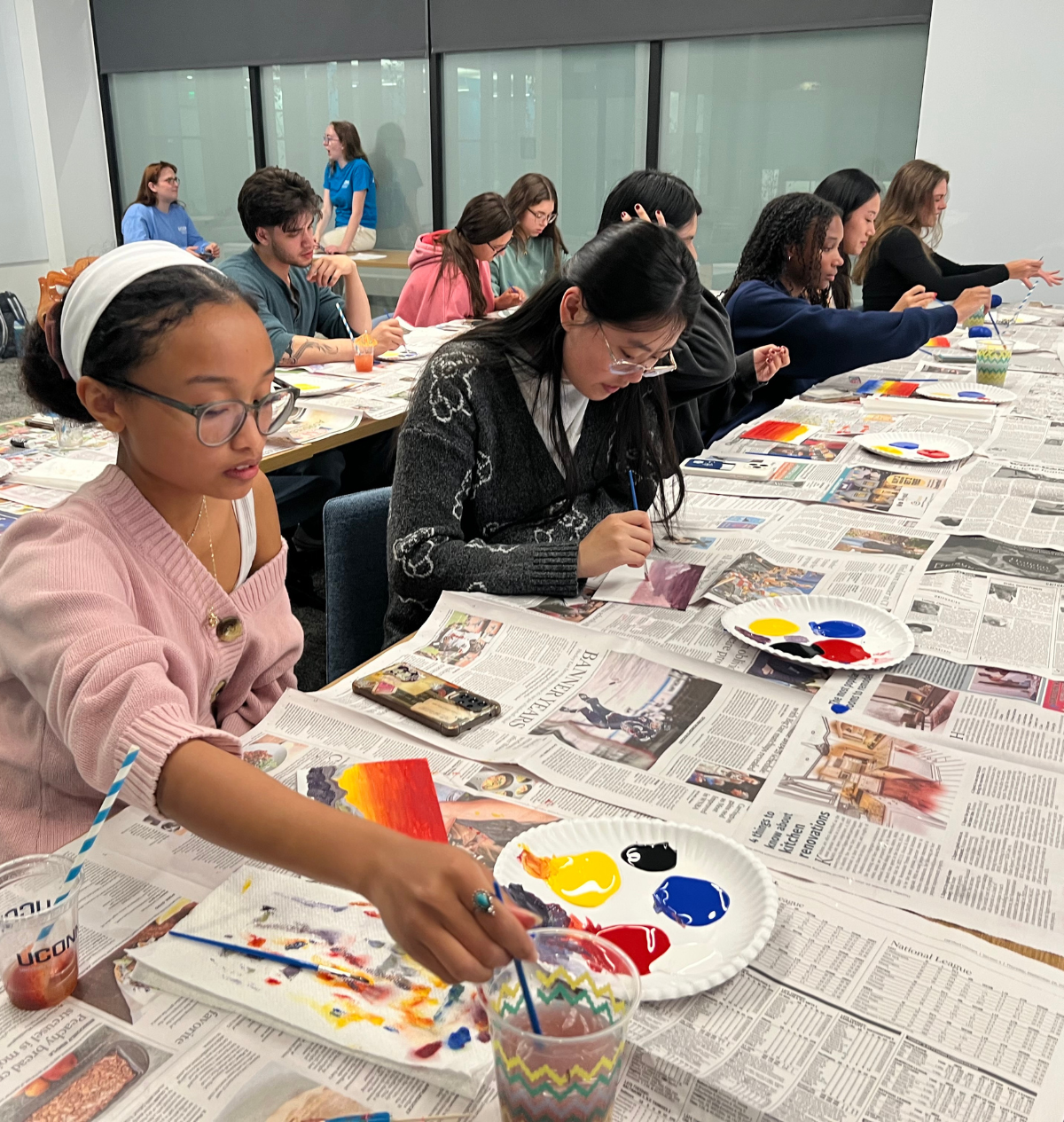 Holistic Huskies painting Students focus on their artwork during a group painting session designed to encourage mindfulness and creativity.