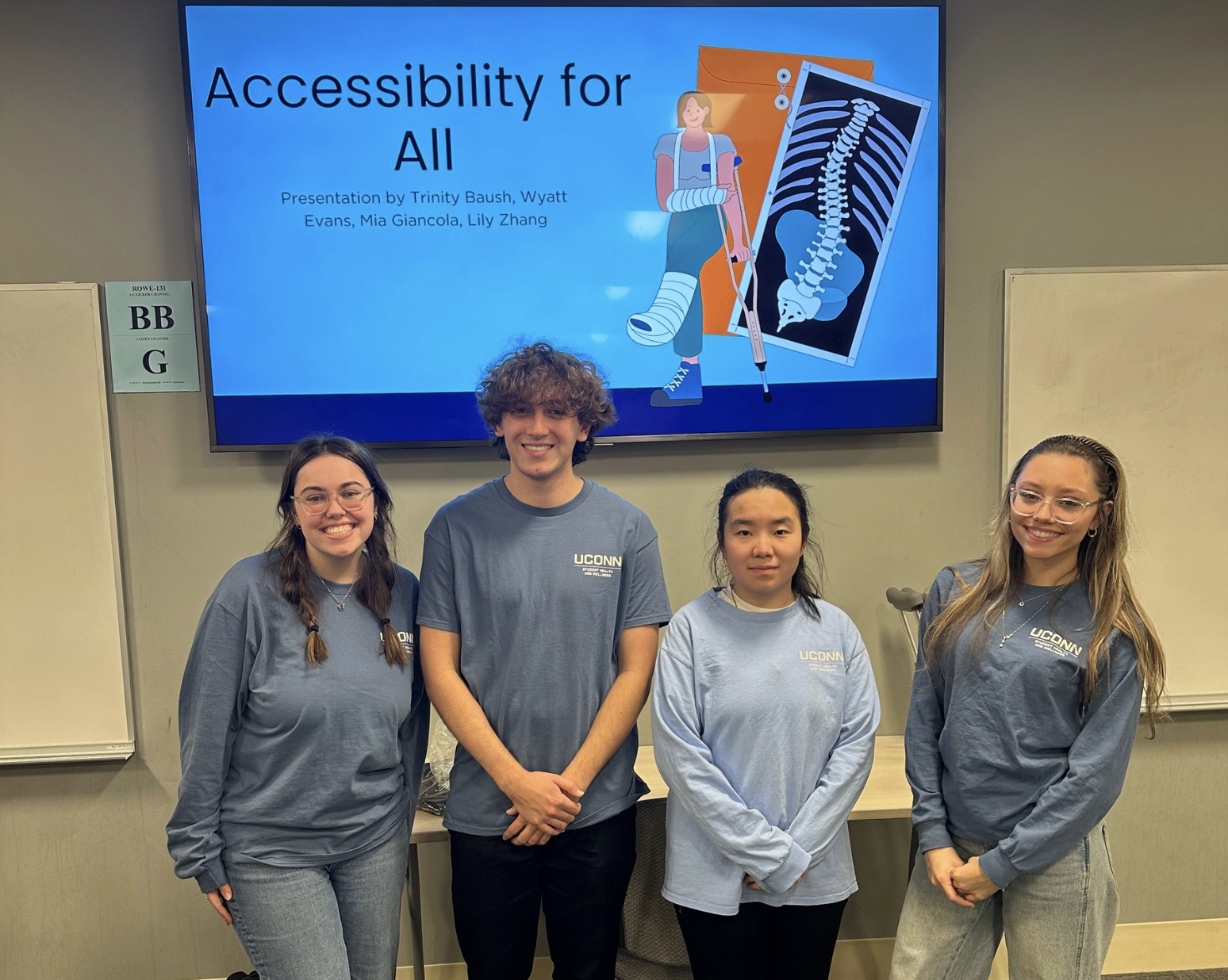 Student team stands in front of a presentation titled “Accessibility for All” during a UConn SHaW educational session.